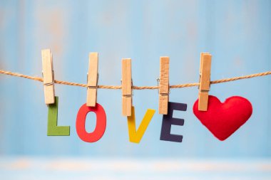 Kırmızı kalp şekli dekorasyon kopya alanı için mavi ahşap arka plan üzerinde metin satırıyla asılı. Düğün romantik ve Happy Valentine s gün tatil kavramı seviyorum