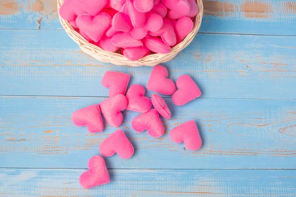 LOVE wooden cubes with pink heart shape decoration on blue table background and copy space for text. Love Romantic and Happy Valentines day holiday concept