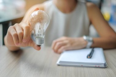 İş kadın el holding ampul veya lamba. Yeni fikir, yaratıcı, deha ve yenilik kavramları