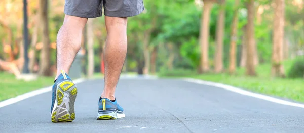 Young athlete man with running shoes in the park outdoor, male r