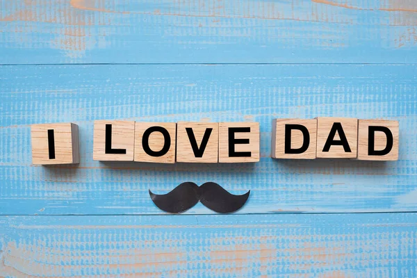 I Love DAD text and mustache on wooden background. Happy Father\'