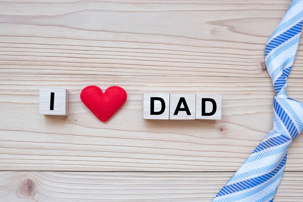 I Love DAD text with red heart shape  on wooden background. Happ