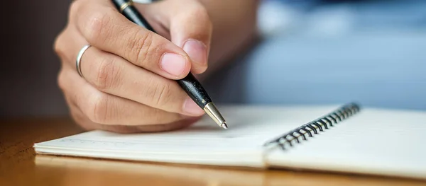 Businesswoman writing something on notebook in office, hand of w — Stock Photo, Image