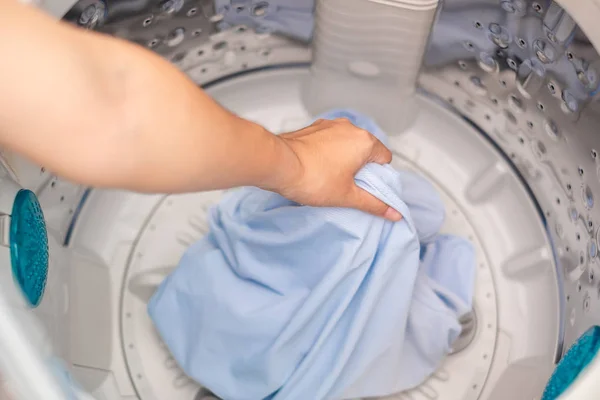 Housewife Woman hand holding clothes inside Washing Machine in l — Stock Photo, Image