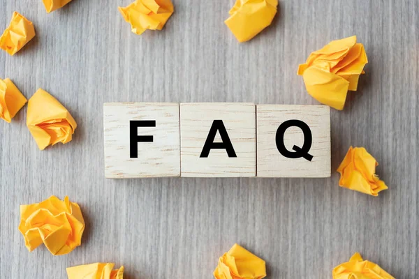 FAQ( frequency asked questions) word with wooden cube block and