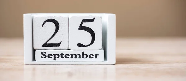 25 September of calendar wooden on table, World pharmacist day c