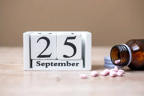25 September of calendar wooden and drug on table, World pharmac