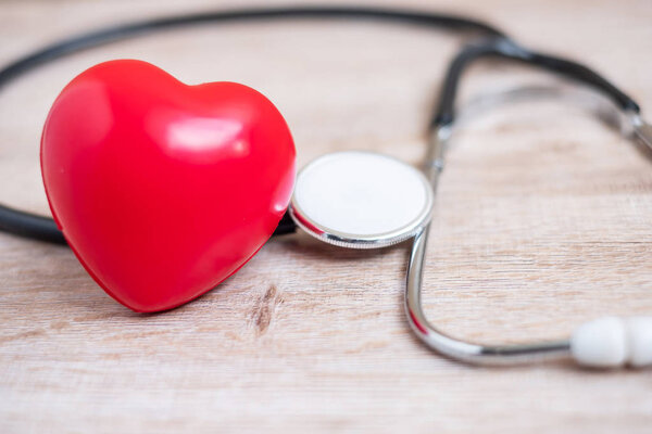 Stethoscope with Red heart shape on wooden background. Healthcar