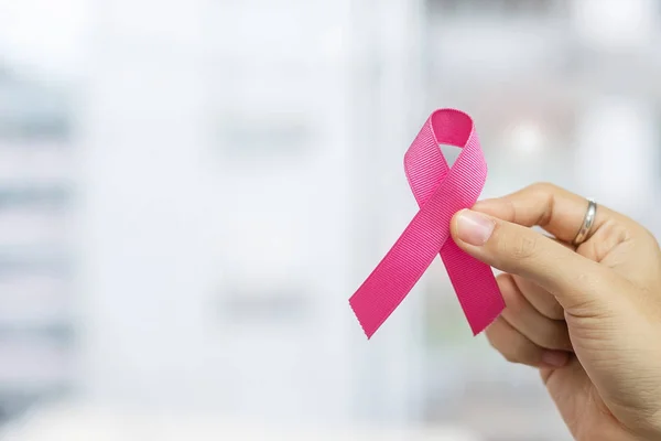 October Breast Cancer Awareness month, Woman holding Pink Ribbon
