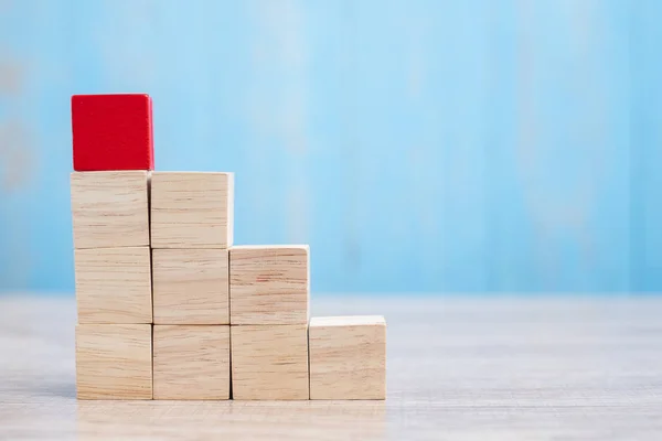 Red wooden block on the building. Business planning, Risk Manage