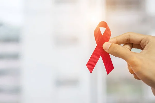 stock image December World Aids Day Awareness month, Man holding Red Ribbon 