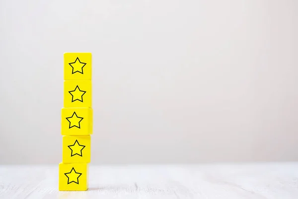 wooden blocks with the star symbol. Customer reviews, feedback, rating, ranking and service concept.