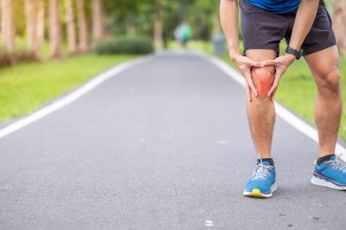 Young adult male with muscle pain during running. runner have knee ache due to Runners Knee or Patellofemoral Pain Syndrome, osteoarthritis and Patellar Tendinitis. Sports injuries and medical concept clipart