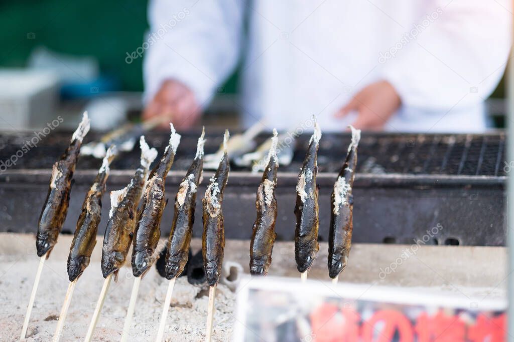 Japanese Fishes grilling, Delicious traditional food in Arashiyama, Kyoto, Japan. Asia travel and Street food concept