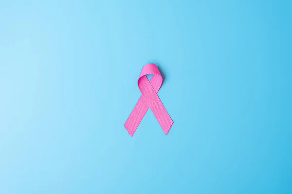 October Breast Cancer Awareness month, Pink Ribbon on blue background for supporting people living and illness. International Women, Mother and World cancer day concept