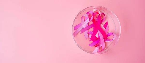 October Breast Cancer Awareness month, Pink Ribbon on pink background for supporting people living and illness. International Women, Mother and World cancer day concept