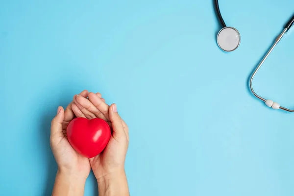 Doctor Hand Holding Red Heart Shape Stethoscope Blue Background Healthcare — Stock Photo, Image