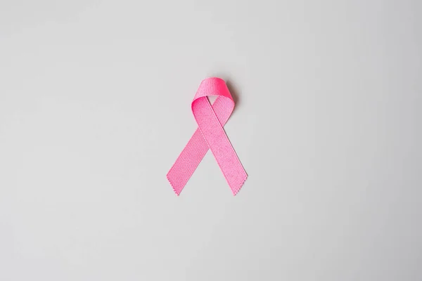October Breast Cancer Awareness month, Pink Ribbon on grey background for supporting people living and illness. International Women, Mother and World cancer day concept