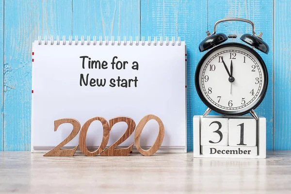 2020 Year  with Time for a New start, note, black retro alarm clock and wooden number. New year, Resolution, Goals, Plan, Action and Mission Concept