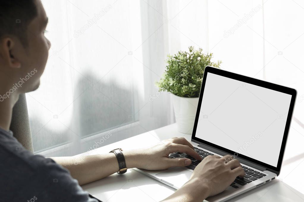 Mockup image of a man working at the laptop 