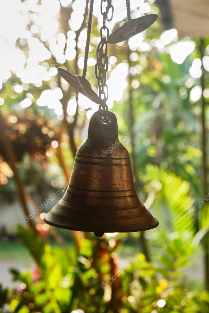Bronze bell at the front door to the house.