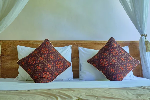 Pillows lying at the head of the bed.