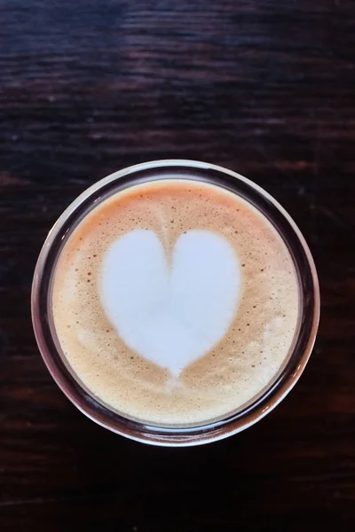 Cup of cappuccino with a heart of foam closeup — Stock Photo, Image