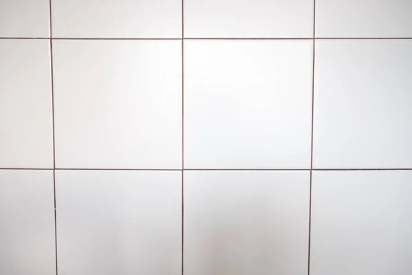 Біла керамічна глянцева плитка крупним планом Стокове Фото