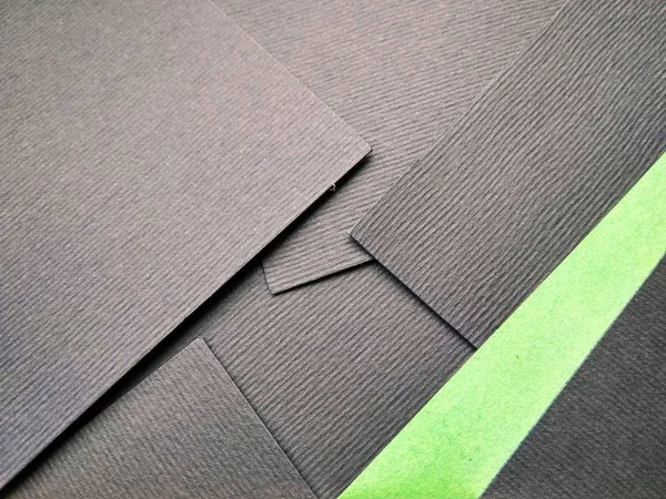 few black papers folded with color paper close up