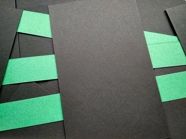 few black papers folded with color paper close up