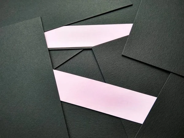 few black papers folded with color paper close up