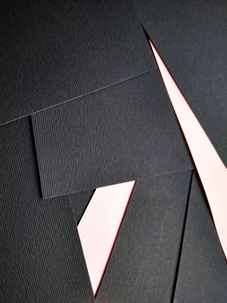 few black papers folded with color paper close up