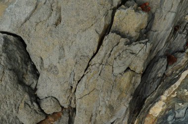 Kaya katmanları - yüzyıllar boyunca yığılmış renkli kaya oluşumları. Etkileyici dokusu olan ilginç bir arka plan..