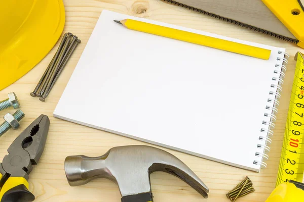 Planificación de proyectos en carpintería y carpintería. Cuaderno y herramientas de carpintería surtidas en mesa de taller de madera de pino . — Foto de Stock