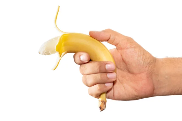 Hand holding a depiled banana in a gun like style. Hands with ob — Stock Photo, Image