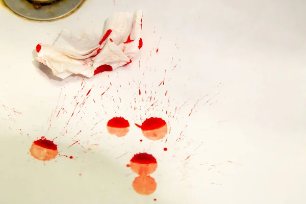 Real drops of blood fallen on a sink along with napking in attem — Stock Photo, Image