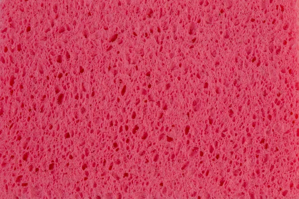 Розовая губка фоновая текстура крупным планом на одной губке для очистки — стоковое фото