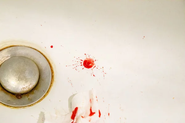 Real drops of blood fallen on a sink. Horror Background for usag