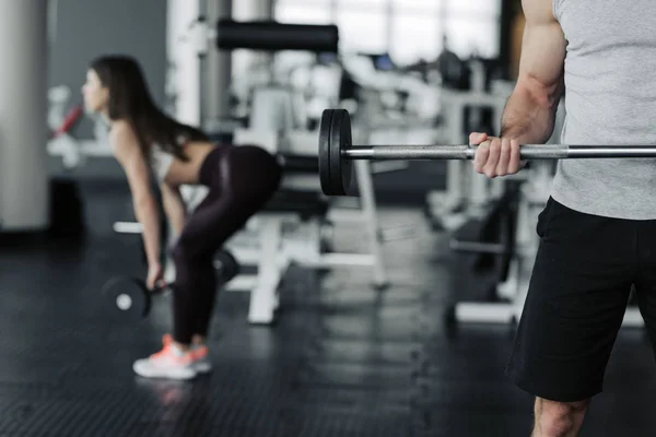 Buena foto de chico y chica haciendo ejercicio con pesas en jym . —  Fotos de Stock