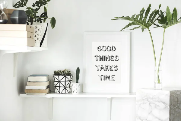 Bright white interior corner with shelves and inspirational phrase in frame on wall