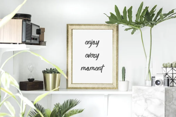 Bright white interior corner with shelves and inspirational phrase in frame on wall