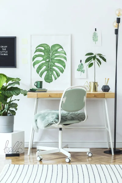 White stylish workplace with botanical art sketches on wall