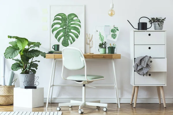 White stylish workplace with botanical art sketches on wall