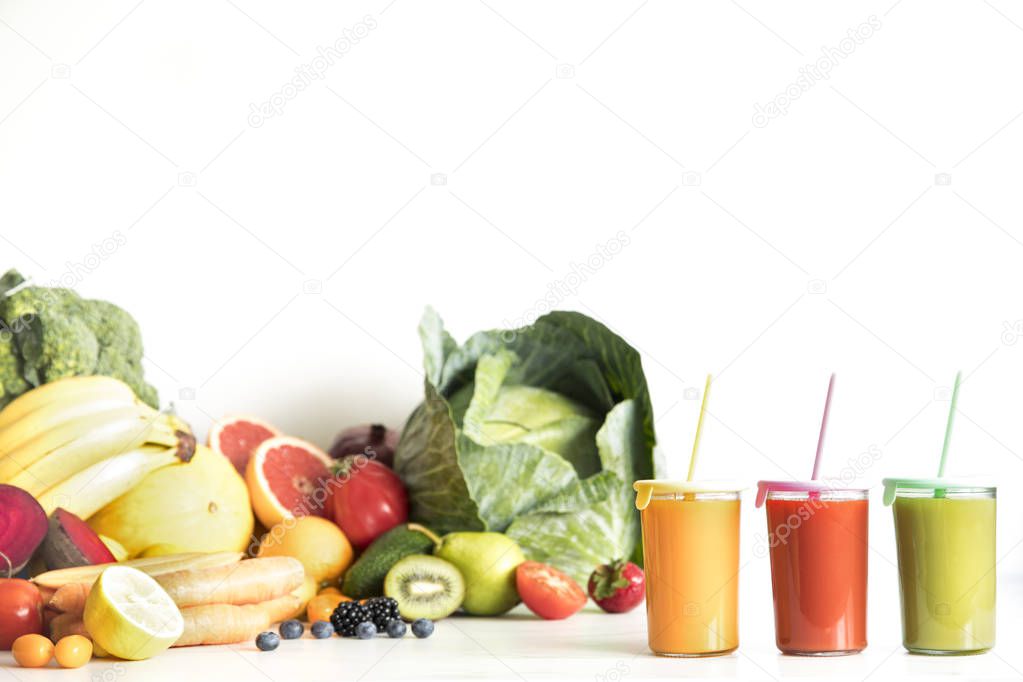 Fresh homemade smoothies with fruits and vegetables on white background