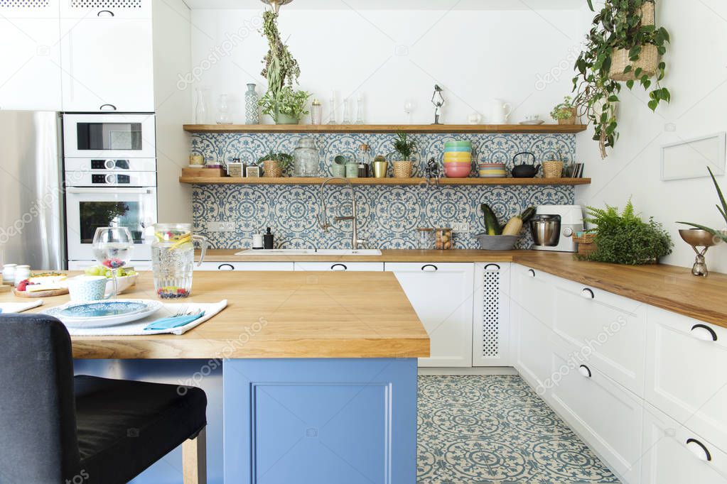Light stylish kitchen in blue colors in Mediterranean style