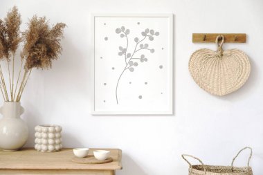 Stylish korean interior of living room with brown mock up poster frame, elegant accessories, flowers in vase, wooden shelf and hanging rattan leaf. Minimalistic concept of home decor. Template.  clipart