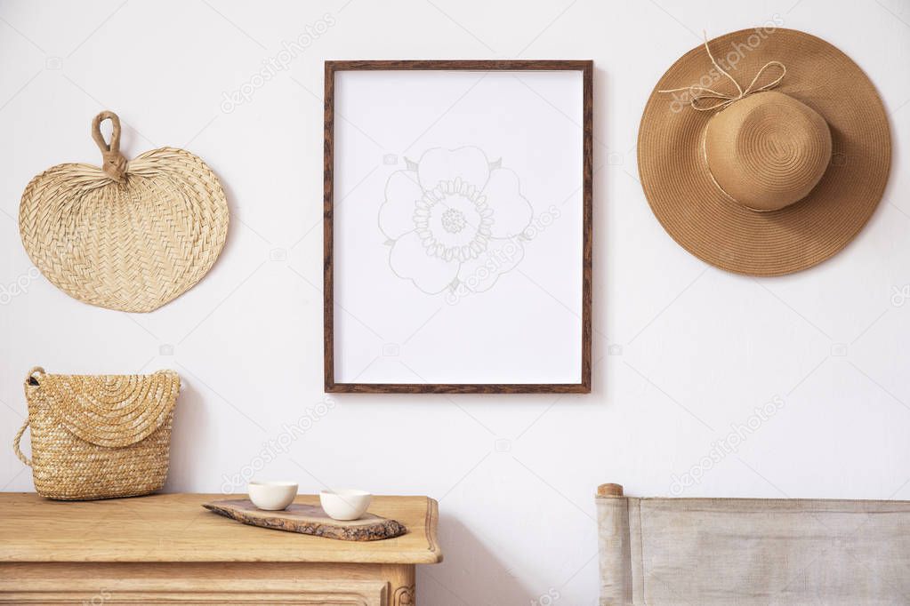 Stylish korean interior of living room with brown mock up poster frame, elegant accessories, chair, wooden shelf and hanging rattan bags and hat. Minimalistic concept of home decor. Template. 