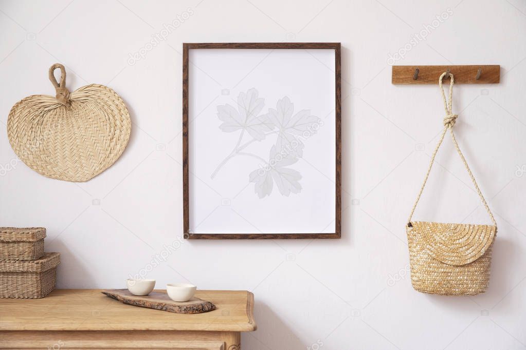 Stylish korean interior of living room with brown mock up poster frame, elegant accessories, boxes, wooden shelf and hanging rattan bag leaf. Minimalistic concept of home decor. Template. Bright room.