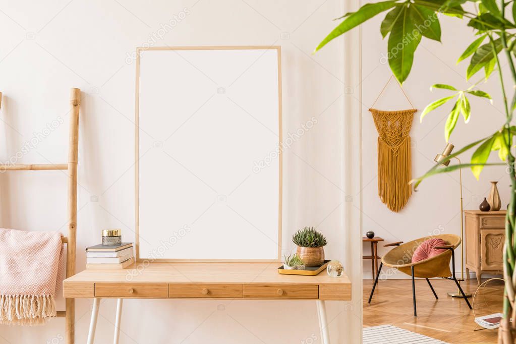Sunny scanidnavian interiors of apartment with mock up poster frame, wooden ladder, gold armchair, design accessories and furnitures, plants and yellow macrame. Stylish home decor of rooms. Real photo