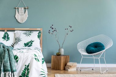 Ahşap yatak, bitki ve zarif aksesuarları ile yatak odası iç minimalist kompozisyon. Güzel çarşaflar, battaniye. Şablon. Tasarım ev dekorasyonu